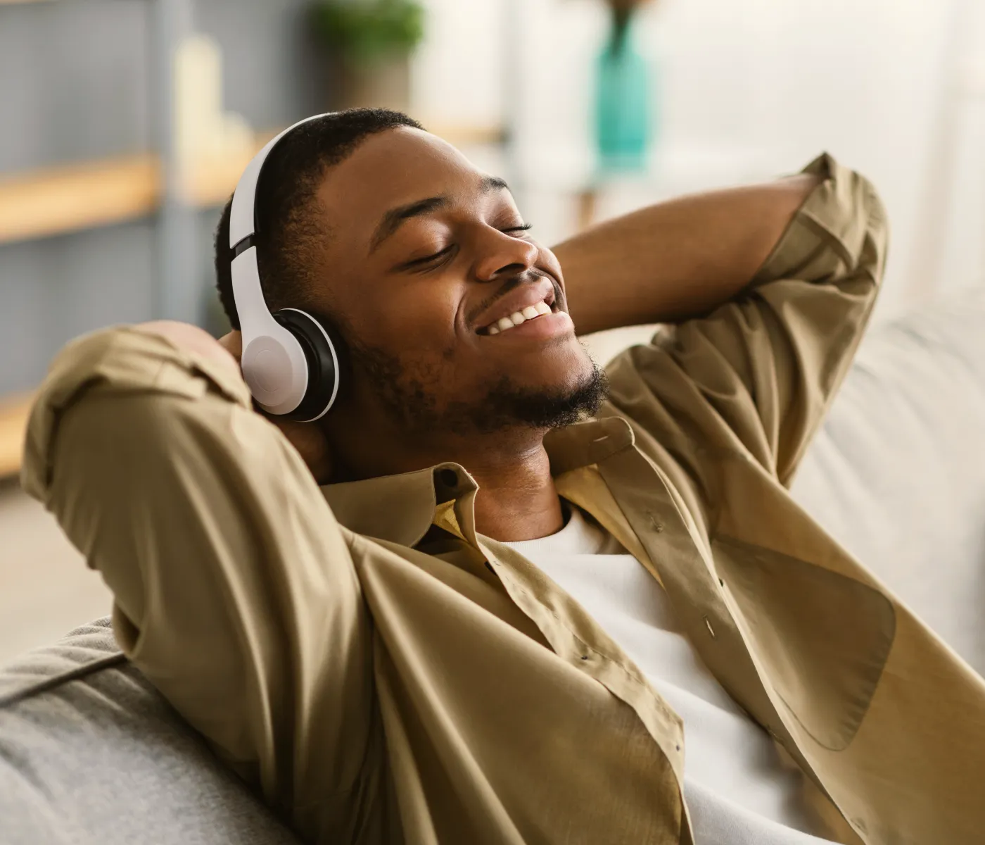 a man wearing headphones is sitting on a couch