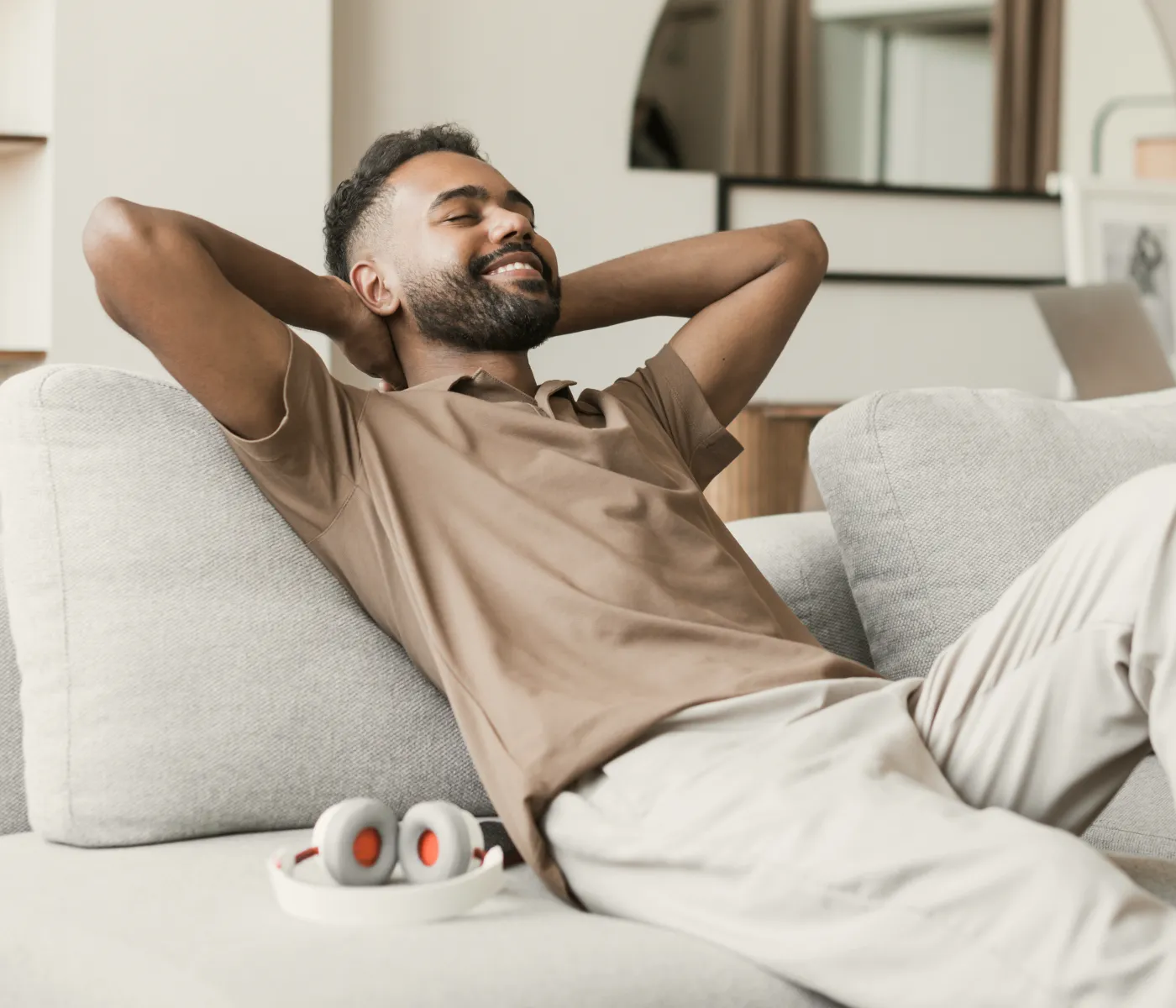 a man sitting on a couch with his feet up