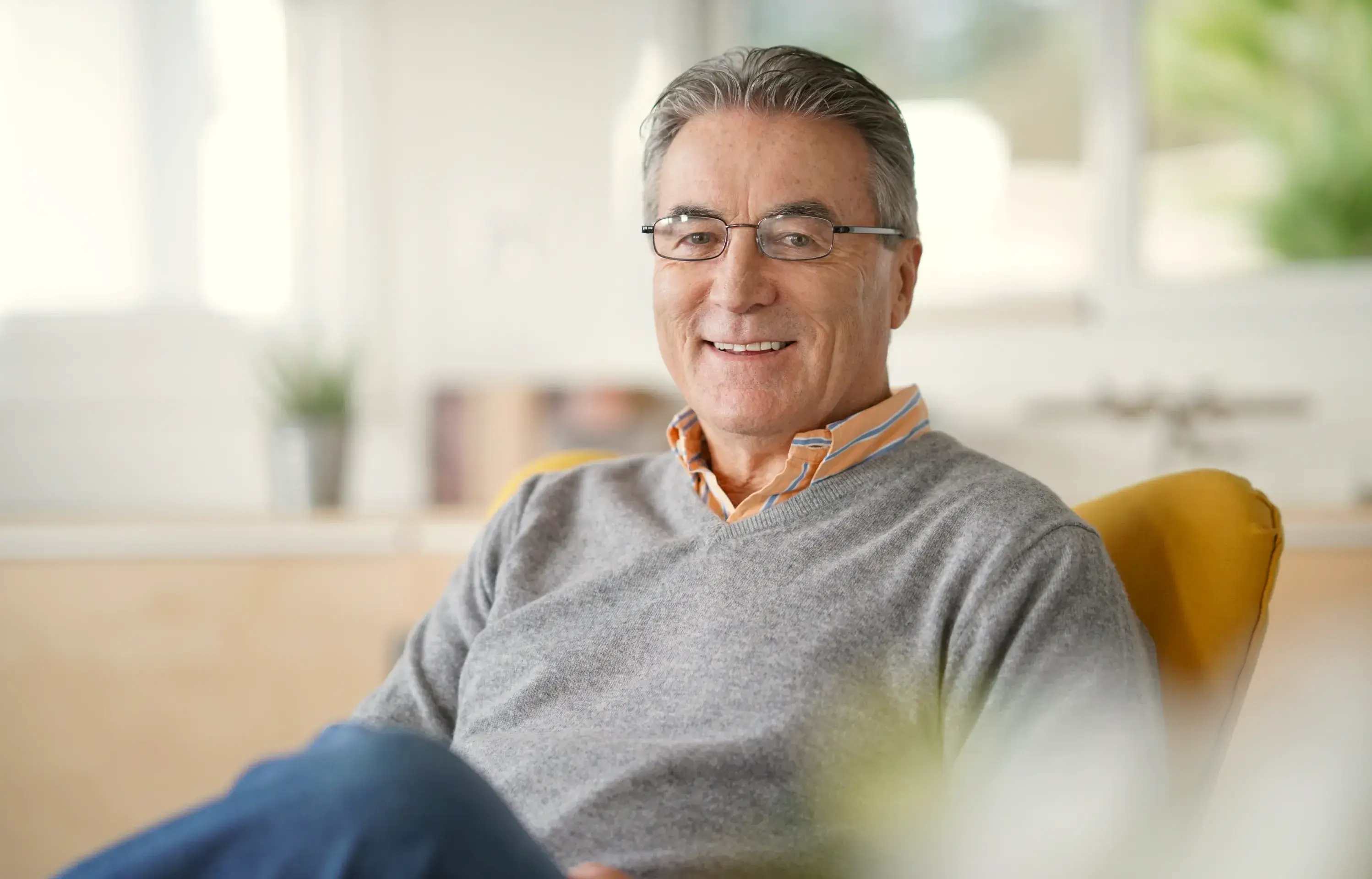 a man sitting in a chair with a smile on his face