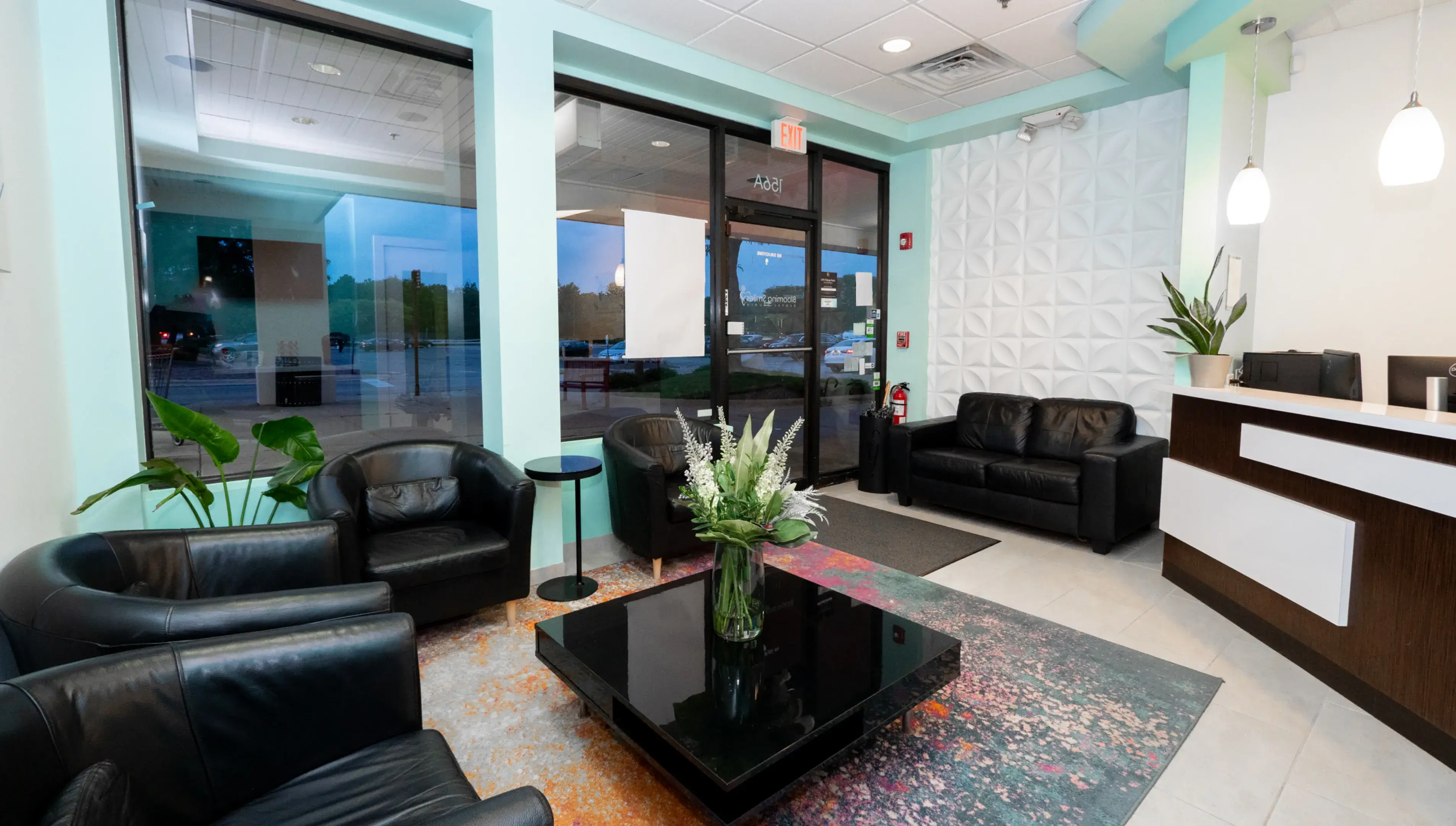 a room with two black leather chairs and a black coffee table