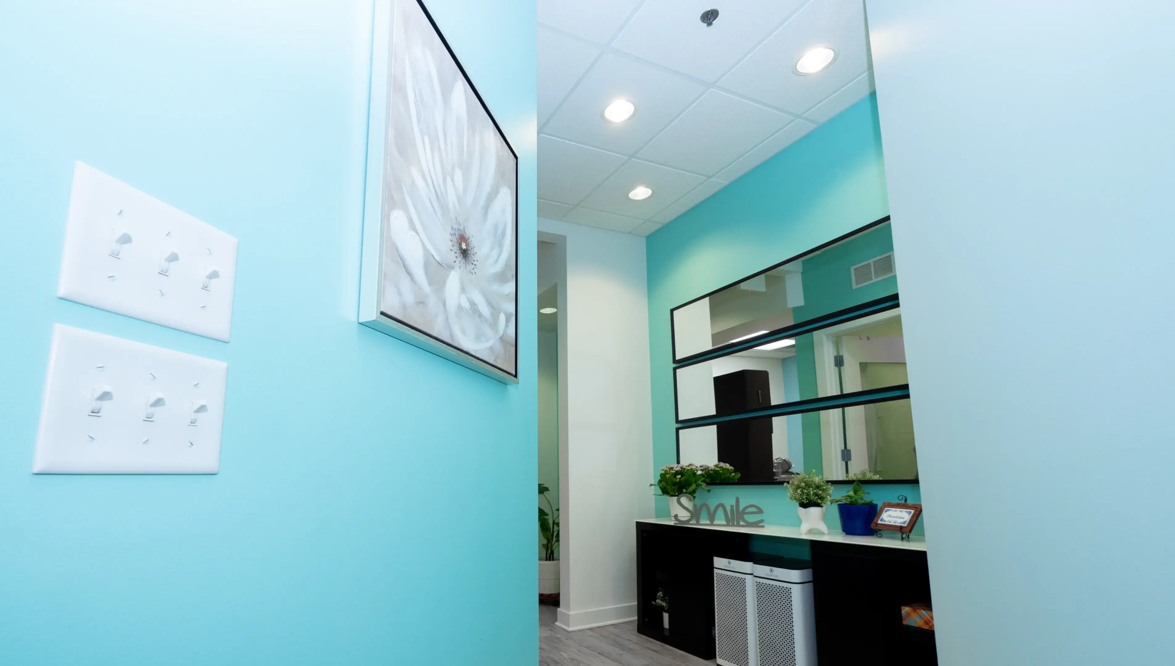 a bathroom with a blue wall and a mirror